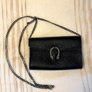 Black clutch with heavy metal strap